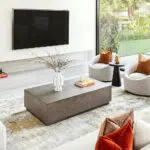 Aurora rug with grey and gold design, styled in a modern living room with a sleek coffee table and bright accents.