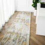 Aurora runner rug with grey and gold abstract design, styled in a bright hallway with wooden flooring.