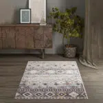 Boho Mirage Rug with geometric patterns and earthy tones, styled in a modern interior with a wooden console table, framed art, and a potted plant.