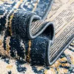 Close-up of the folded edge of Khalifa Imperial Rug showing its high-quality craftsmanship, intricate weave, and luxurious black and beige design.