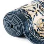 Rolled view of the Khalifa Imperial Rug showcasing its soft texture, durable edges, and elegant black and beige design.