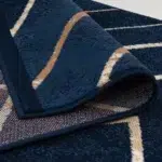 Close-up of Alhambra Geometric Rug showcasing its soft texture and bold geometric patterns in navy blue.