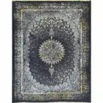 Close-up of Algiers Rug, a Persian-style carpet with intricate floral patterns in black, ivory, and gold, made from acrylic with a cotton backing.