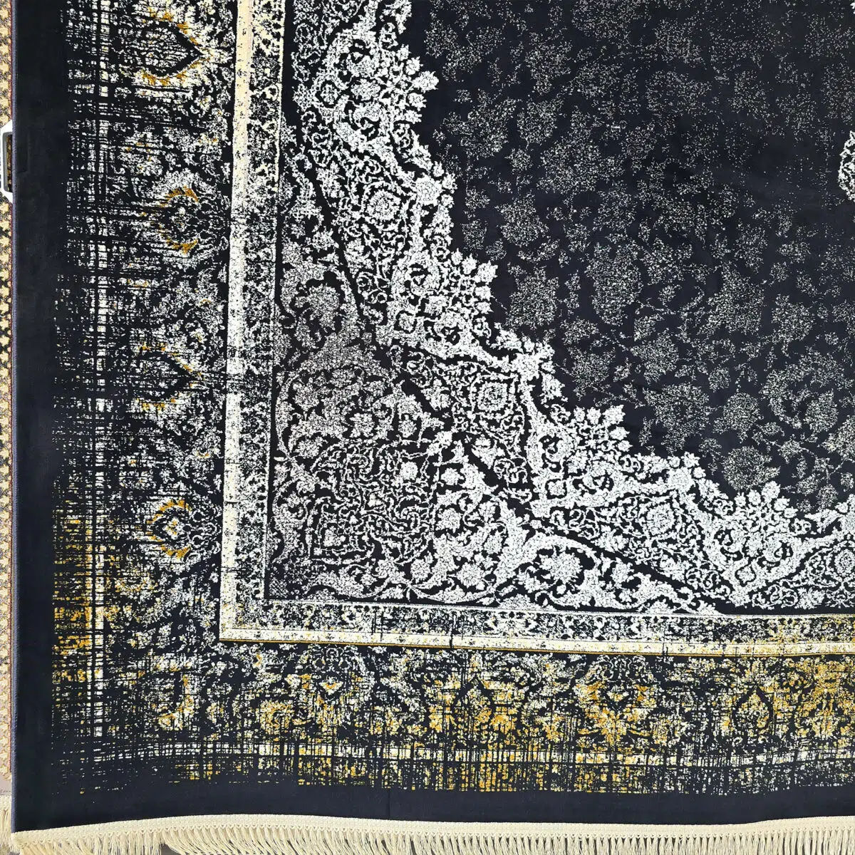 Close-up of the Algiers Rug’s intricate border, showcasing elegant Persian motifs in black, ivory, and gold with hand-finished fringes.
