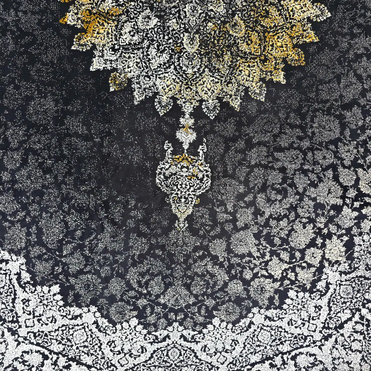 Close-up of Algiers Rug’s intricate Persian medallion design, featuring black, ivory, and gold tones with detailed floral patterns.