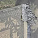 Close-up of Alhambra Royal Rug’s microfilament backing and hand-knotted fringe, highlighting its 1200 reeds, 3600 density, and premium acrylic construction.