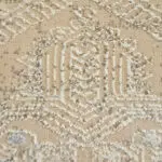 A close-up of the Babylon Rug’s raised textured motif, showcasing a high-pile geometric Persian-inspired pattern in soft beige and ivory hues, adding depth and dimension to any luxury interior.