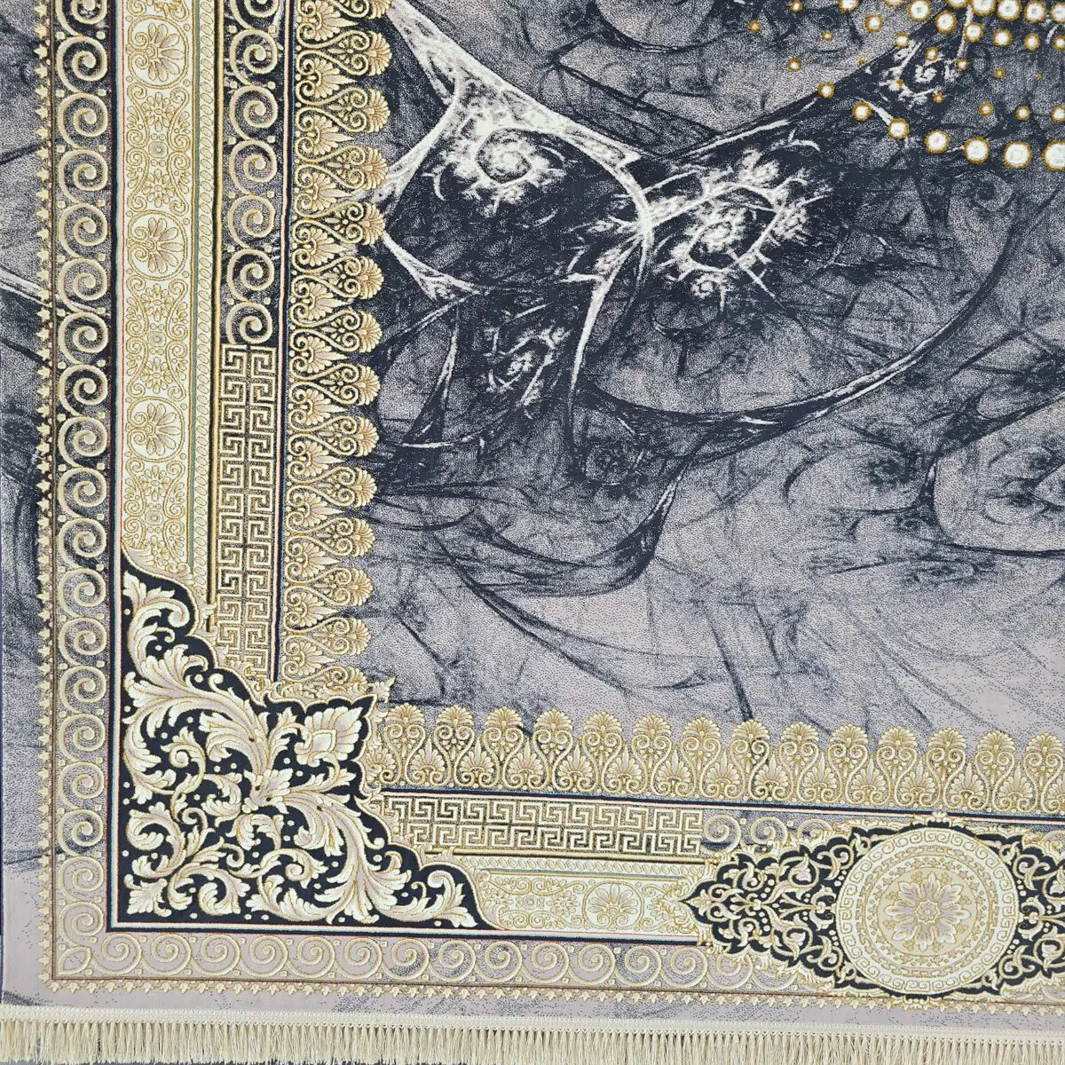 Close-up of the Baghdad Carpet’s richly woven border, showcasing gold-accented patterns, floral motifs, and classic ornamental details.