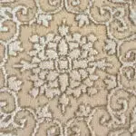 A close-up of the Baroness Carpet, showcasing intricate floral motifs in ivory and beige, woven with 480 reeds precision. The soft, plush texture highlights Persian-inspired elegance, ideal for luxury homes, designer interiors, and boutique hotels.