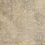 A close-up of the Celeste Rug’s intricate floral medallion pattern in beige, blue, and gold accents, adding a timeless classic charm to interiors.