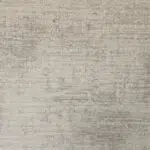 Close-up view of the Doha Carpet’s distressed texture in ivory and soft taupe, showcasing its elegant vintage finish.