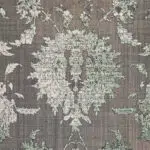 Close-up of the Emerald Carpet’s intricate floral motif, showcasing distressed vintage detailing in soft green, taupe, and ivory tones.