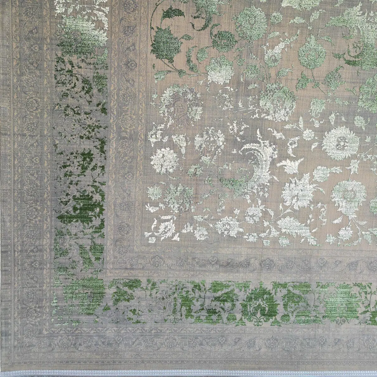 Close-up of the Emerald Carpet’s border, featuring intricate floral detailing, distressed green tones, and a vintage-inspired aesthetic.