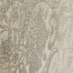 Close-up view of the Emir Carpet’s textured floral pattern with antique gold and silver accents on a soft neutral background.