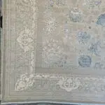 A close-up of the Imperial Carpet’s elegant border, featuring intricate floral motifs in Antique Beige and Royal Blue.