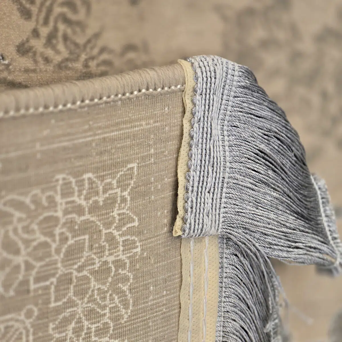 Close-up of the Imperial Carpet’s fringe and border, showcasing intricate weaving in soft Antique Beige and Ivory tones.