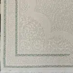 A close-up of the Jeddah Carpet’s intricately designed border with elegant Persian-style patterns in soft neutral and green tones, finished with refined fringes.