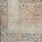 A close-up of the Kazakh Rug’s detailed geometric patterns and distressed vintage-inspired finish in earthy tones.