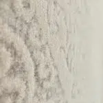 Close-up of the Kuwait Carpet’s plush and textured surface, showcasing its intricate Persian design, high-quality weave, and soft, neutral-toned pile for luxury interiors and wholesale buyers.
