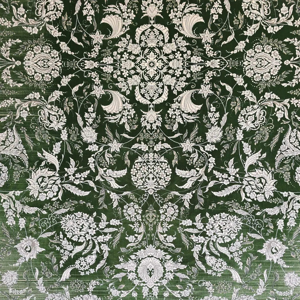 A detailed close-up of the Majestic Carpet, showcasing its refined floral pattern with silver threads against a deep green background, ideal for luxury interior décor.