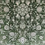 A detailed close-up of the Majestic Carpet, showcasing its refined floral pattern with silver threads against a deep green background, ideal for luxury interior décor.