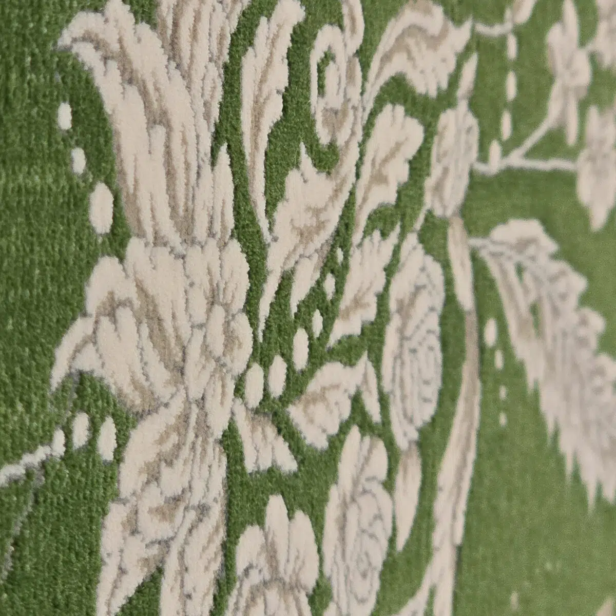A close-up of the Majestic Carpet’s plush floral texture, featuring an elegant contrast of ivory botanical motifs against a deep green background.