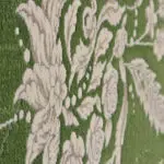 A close-up of the Majestic Carpet’s plush floral texture, featuring an elegant contrast of ivory botanical motifs against a deep green background.