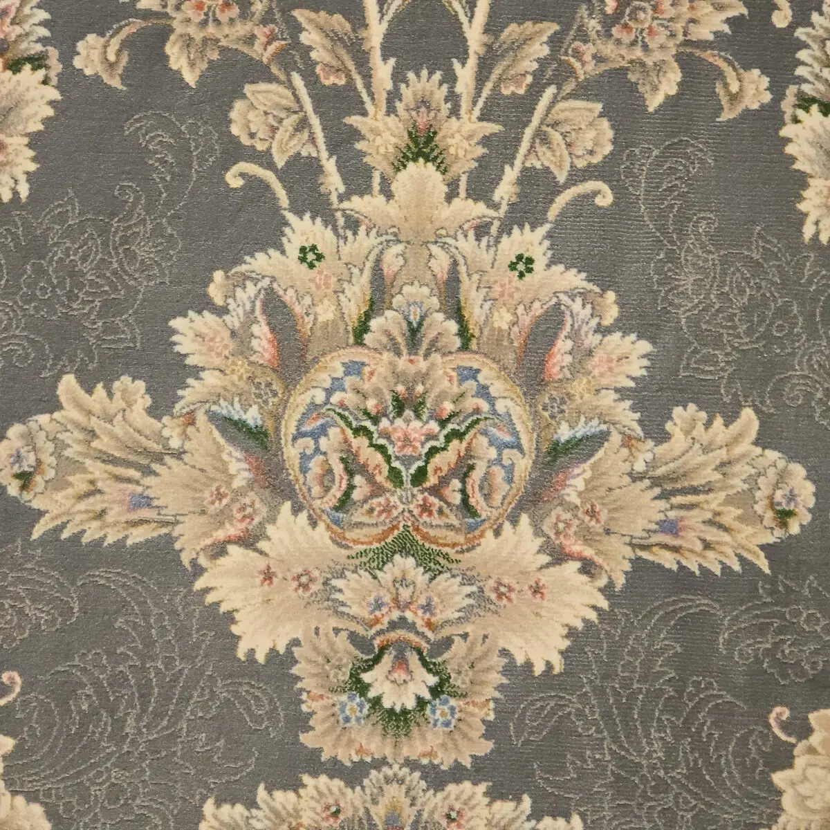 A detailed close-up of the Malik Carpet, showcasing its intricate Persian floral motifs in beige, navy blue, and pastel accents, woven with 1200 reeds for a refined finish.