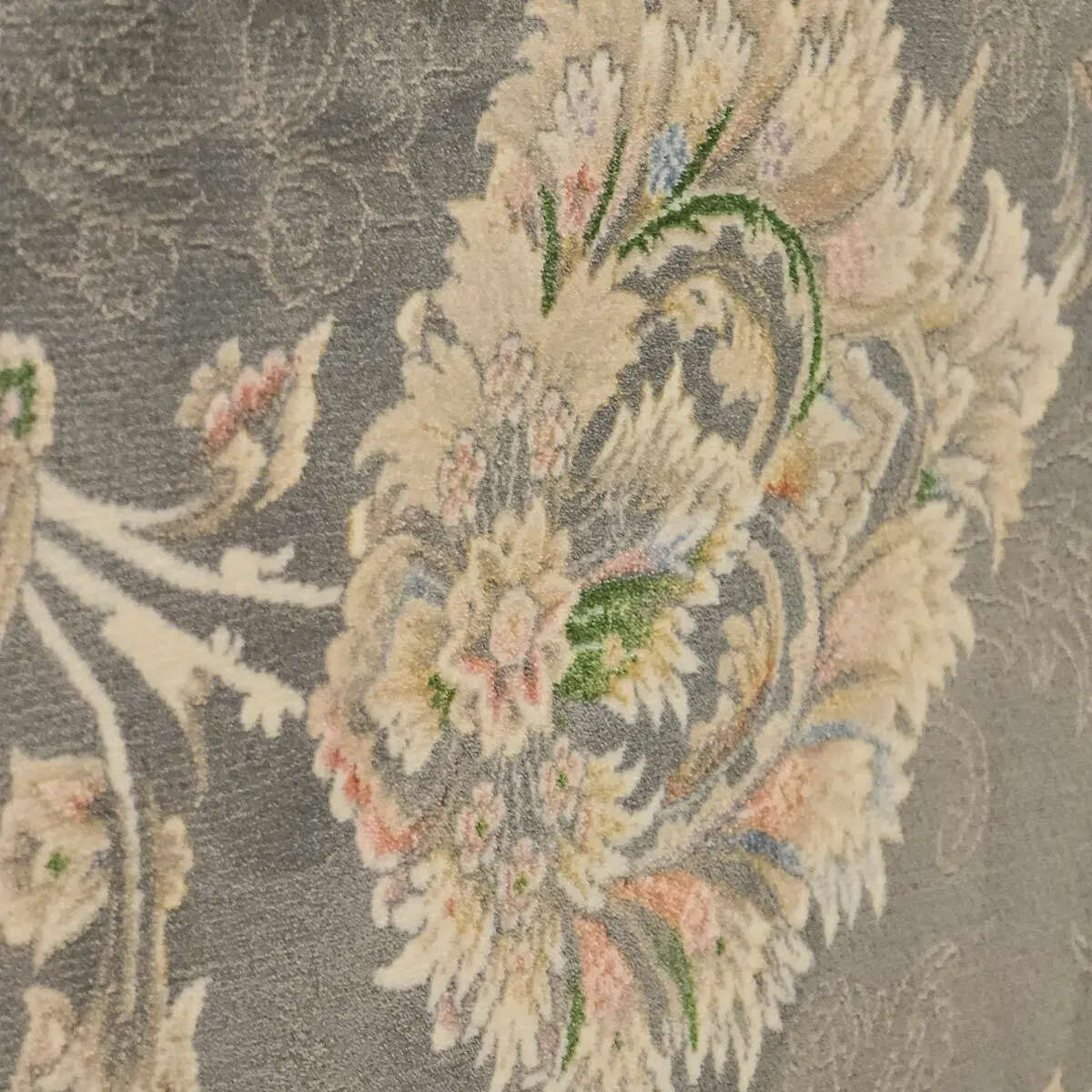 A detailed close-up of the Malik Carpet’s floral motifs, showcasing soft beige, pastel pink, blue, and green accents on a navy grey background. This premium 1200 reeds carpet is ideal for classic interiors.