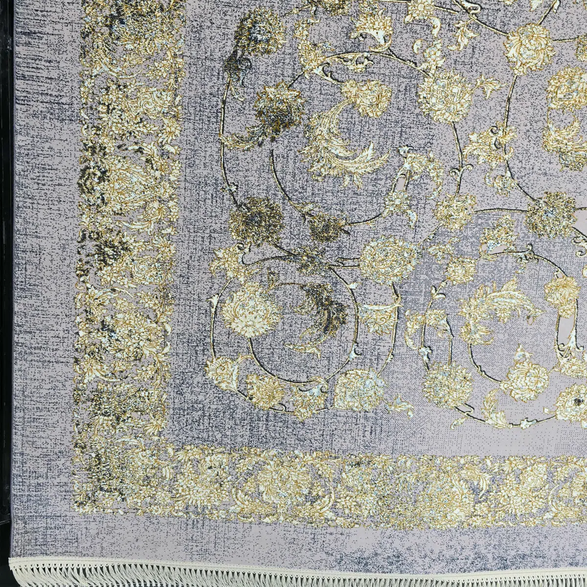 Close-up of the Najran Carpet’s finely woven border and floral detailing, showcasing gold and silver accents.