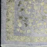 Close-up of the Najran Carpet’s finely woven border and floral detailing, showcasing gold and silver accents.