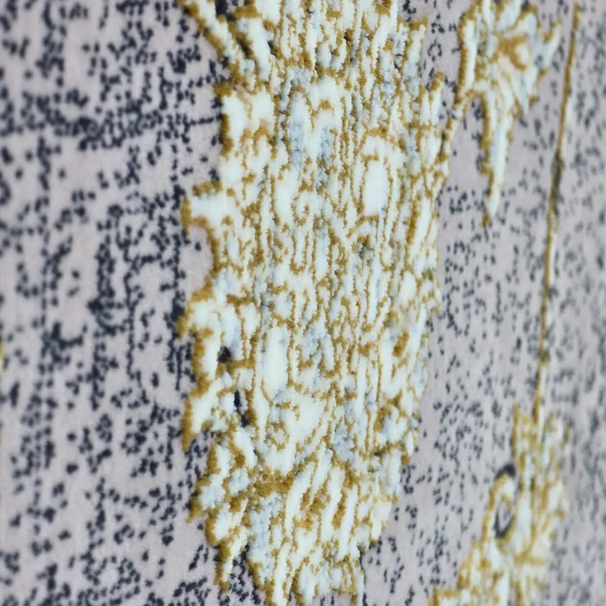 Extreme close-up of the Najran Carpet, highlighting its raised floral weaving with soft gold and silver details.
