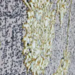Extreme close-up of the Najran Carpet, highlighting its raised floral weaving with soft gold and silver details.