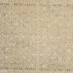 Detailed close-up of the Nomad Haven Rug, showcasing its intricate geometric patterns and textured woven surface in warm, earthy tones.