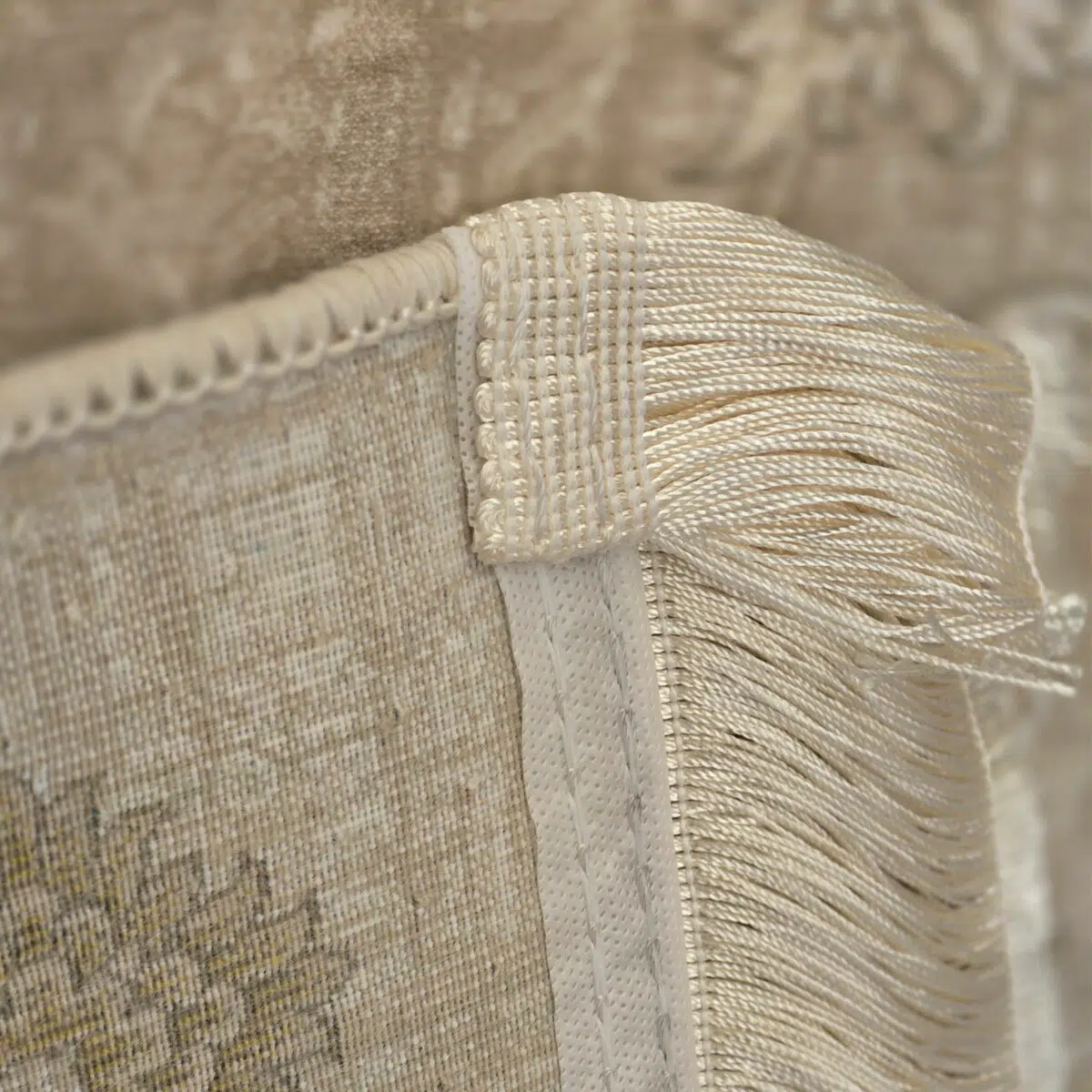 A close-up of Noor Carpet’s hand-tied fringe and durable backing, showcasing fine craftsmanship and high-quality weaving.