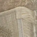 A close-up of Noor Carpet’s hand-tied fringe and durable backing, showcasing fine craftsmanship and high-quality weaving.