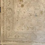 Close-up of Noor Carpet’s elegant border and floral motifs, showcasing intricate Persian craftsmanship in warm beige and gold tones.