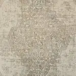 Close-up of the Regency Royal Carpet’s ornate medallion in beige and gold, showcasing intricate swirling motifs and a subtle distressed finish.
