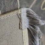 A close-up view of the Royal Bloom Carpet’s finely woven fringe, displaying meticulous craftsmanship and durable finishing.