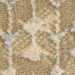 An extreme close-up of the Samarkand Carpet, highlighting its plush texture, intricate distressed Persian-inspired pattern, and warm beige and taupe hues.