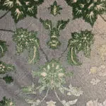 A close-up view of the Samarra Carpet’s high-definition floral weaving in green, beige, and gray tones.