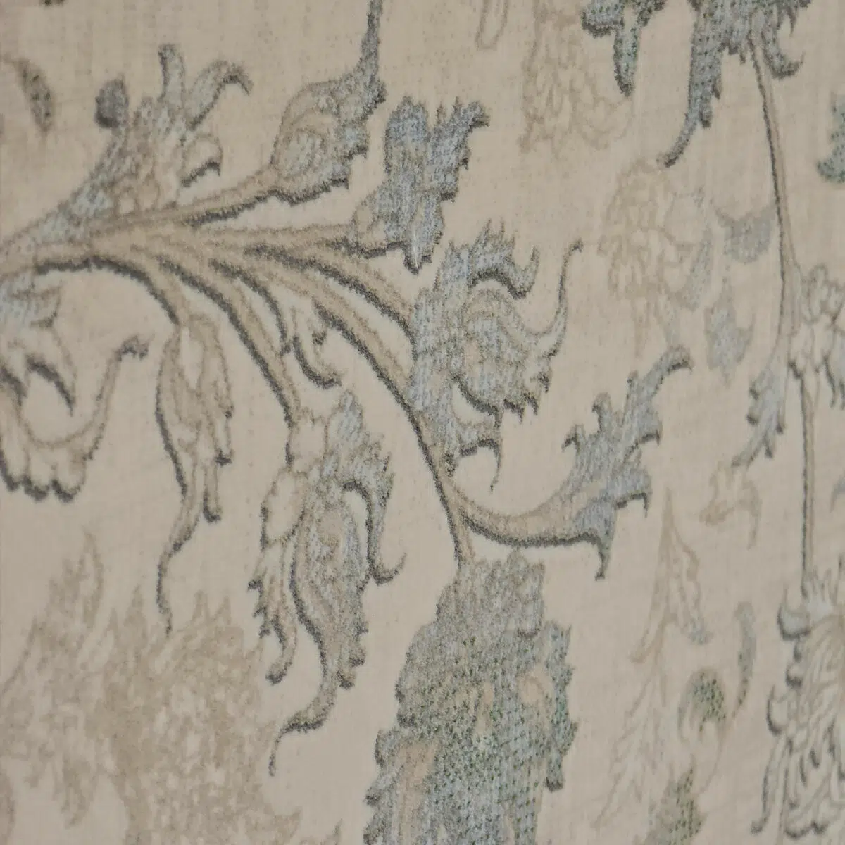 Close-up of the Seraphic Carpet’s intricate floral vine design in soft blue and beige, woven with precision for a timeless aesthetic.