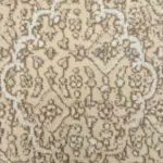A close-up of the Seville Moorish Carpet’s plush texture, featuring intricate Persian floral motifs in warm beige and taupe tones.