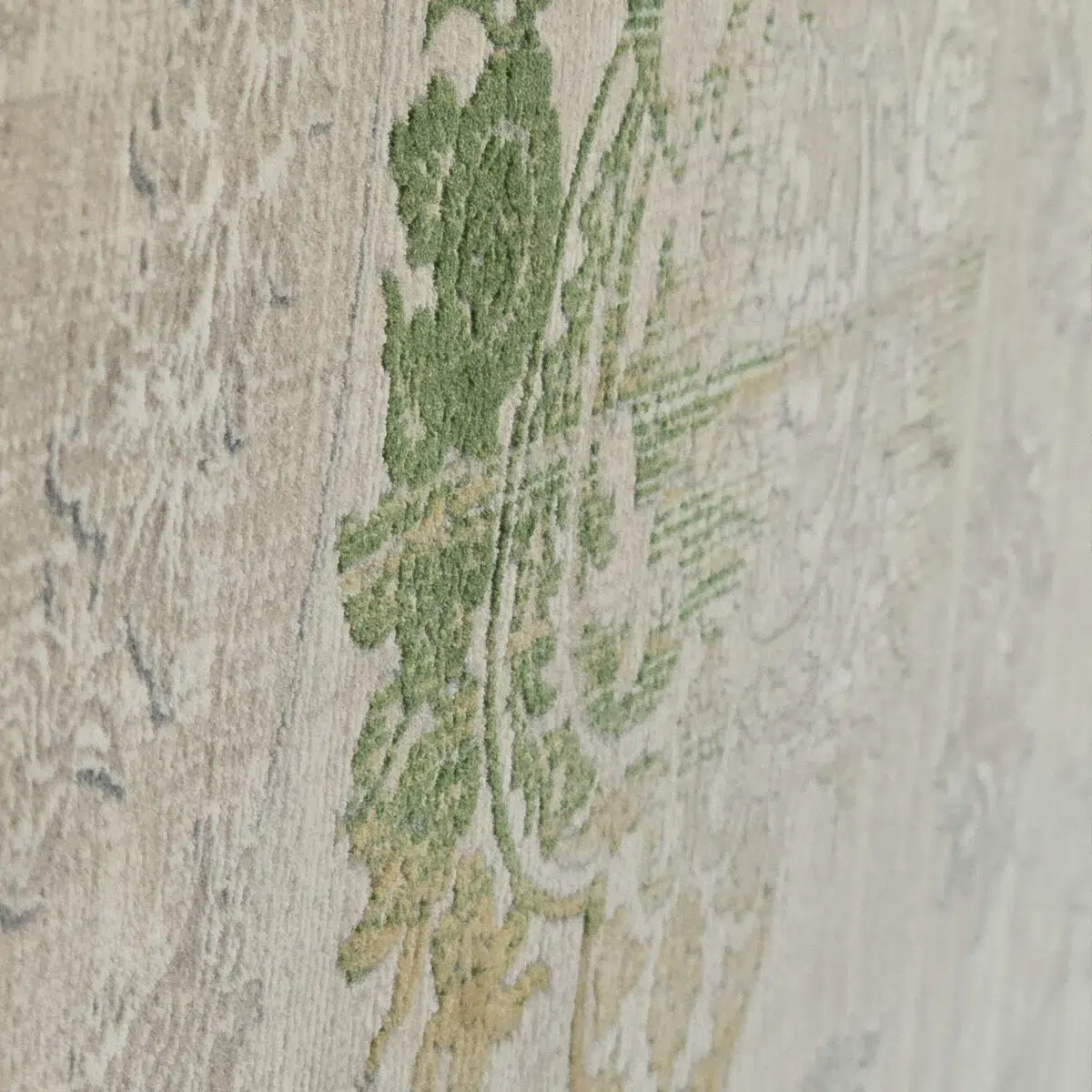 Close-up of the Sultan Carpet’s raised floral patterns in green and gold, highlighting its high-quality texture and craftsmanship.