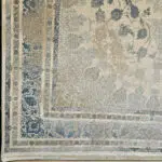 Close-up of the Sultan Qaboos Rug’s intricate border, showcasing floral motifs and fine craftsmanship in beige, gold, and blue tones.