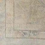 A detailed view of the Tectonic Minimalism Rug’s corner, featuring intricate geometric linework in beige and neutral tones.
