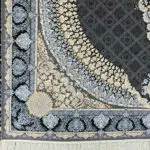 A detailed look at the intricate floral border design of the Doha Majesty Carpet in black and gold.