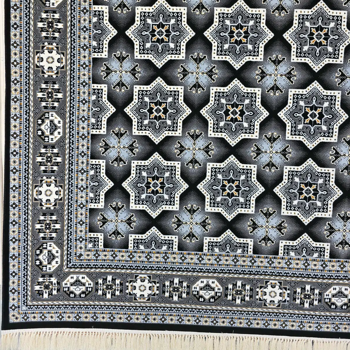 High-resolution close-up of the geometric star pattern on the Kuwait Royal Carpet, featuring black, ivory, and gold tones.