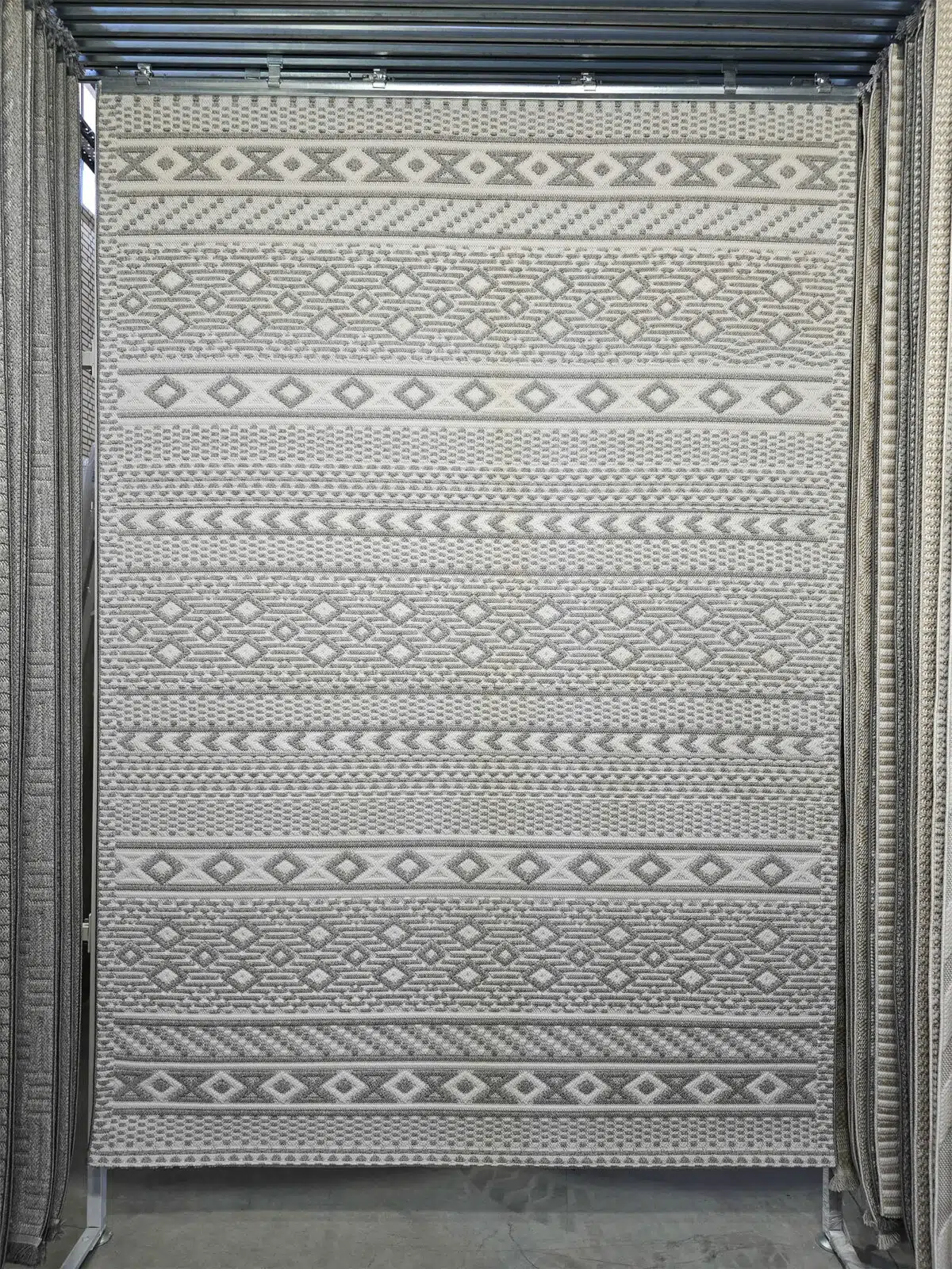 Full hanging view of Equinox rug with grey-white diamond patterns and modern ethnic stripes