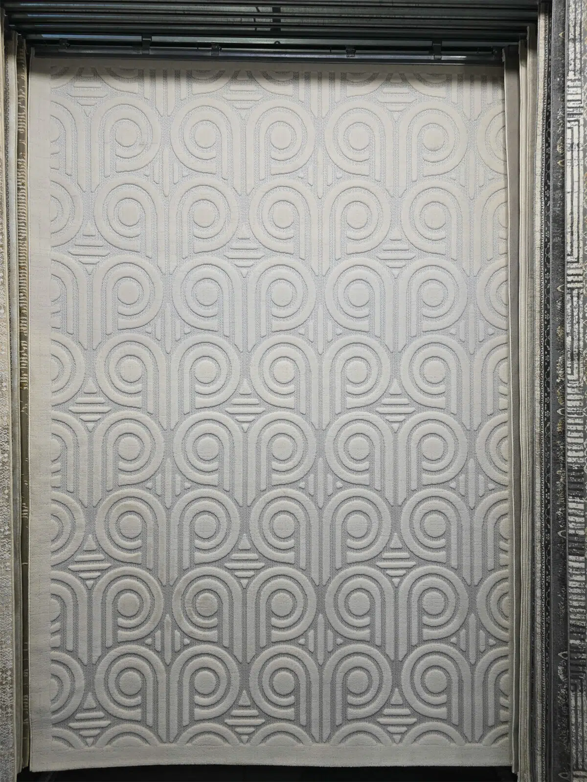 Full front view of Nebula rug showcasing modern circular loop patterns in soft cream
